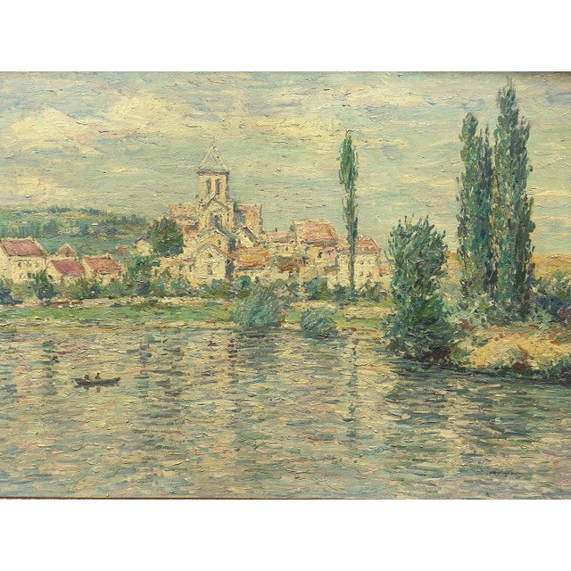 20th-century signed oil on canvas river landscape depicting a tranquil riverside village scene with a central church...