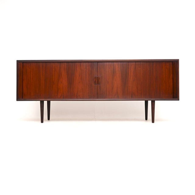 A stunning Danish vintage sideboard by Send Aage Larsen for Faarup Mobelfabrik. This was made in Denmark, it dates from...