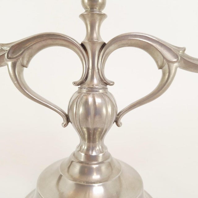 A pair of three-arm pewter candelabras designed by Just Andersen, Denmark in 1929. Their flowing art deco lines and...