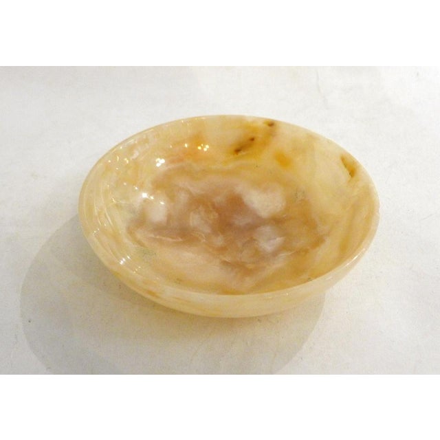 Large, round, flat trinket dish made entirely of marbled beige ochre onyx stone