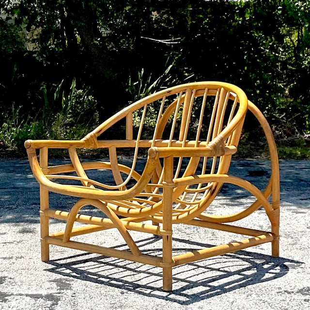 Embrace coastal relaxation with our Vintage Coastal Bent Rattan Lounge Chair. Handcrafted in the USA, this chair...