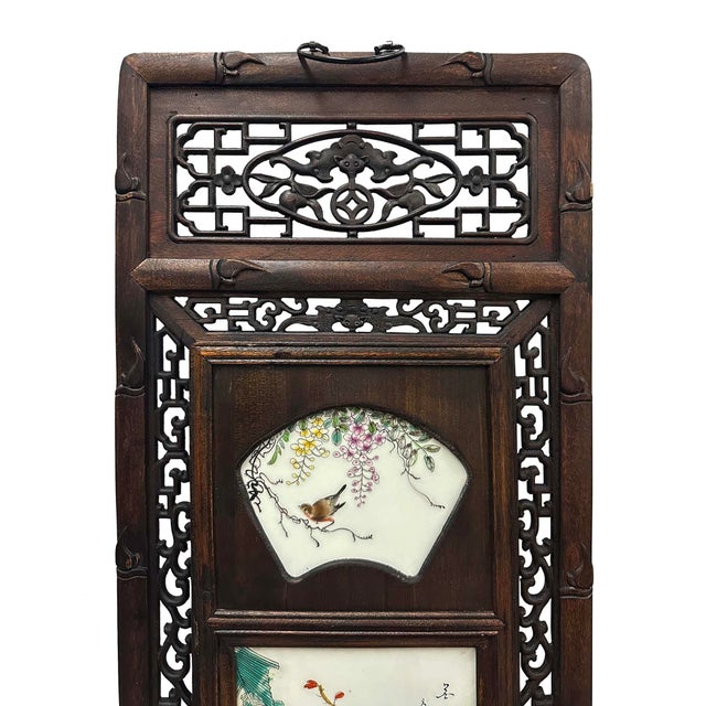 This is a set of four Chinese wall plaques featuring hand-painted porcelain inlays. Each panel is meticulously crafted...