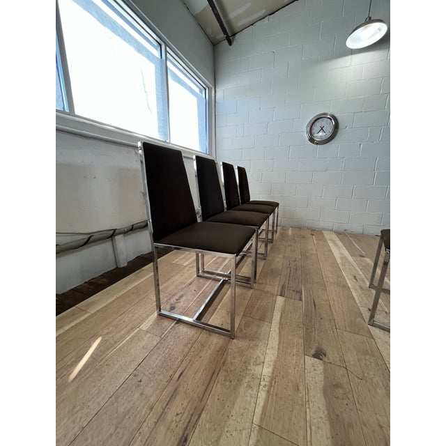A striking set of four modern thin frame dining chairs, executed in the iconic mid-century style attributed to Milo...