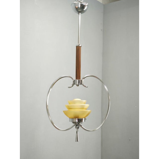 Beautiful Art Deco pendant chandelier produced in Czechoslovakia during the 1930s. This sophisticated chandelier features...