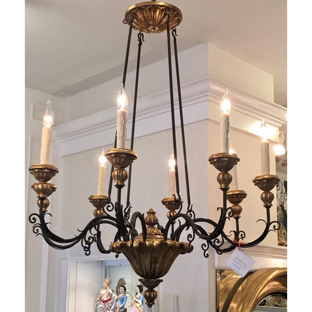 Gold and black Italian Giltwood and iron chandelier by Randy Esada Designs for Prospr. This lovely chandelier is a...