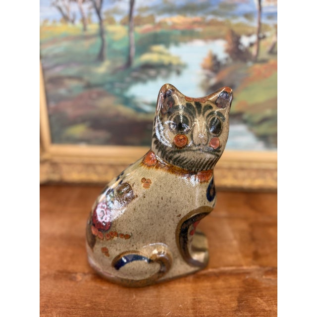 This charming vintage cat figurine is a lovely example of Mexican folk pottery. Hand-painted with whimsical facial...