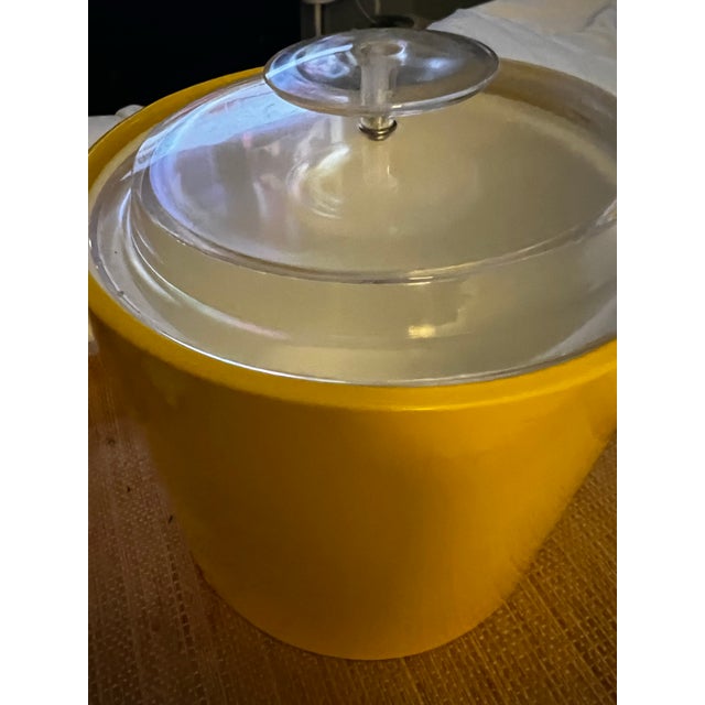 Gorgeous vintage 1970s yellow ice bucket attributed to Georges Briard, featuring an exceptional Mid Century Modern design...