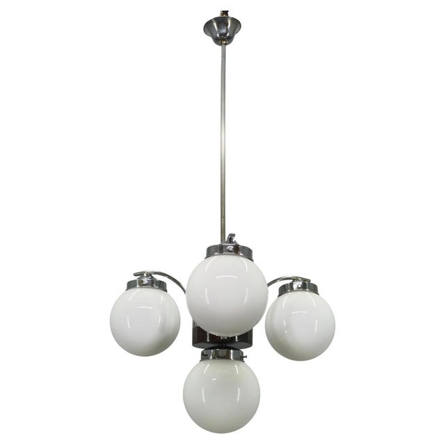 This elegant period fixture combines chrome-plated metal construction with stained wood accents and four beautifully...