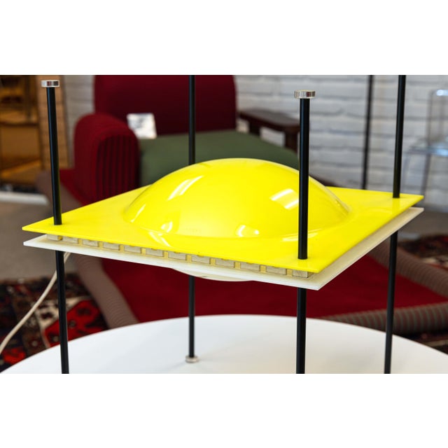 A postmodern space age “UFO Lamp” designed by Ettore Sottsass for Arredoluce, Italy 1957. Molded plastic, enameled brass,...