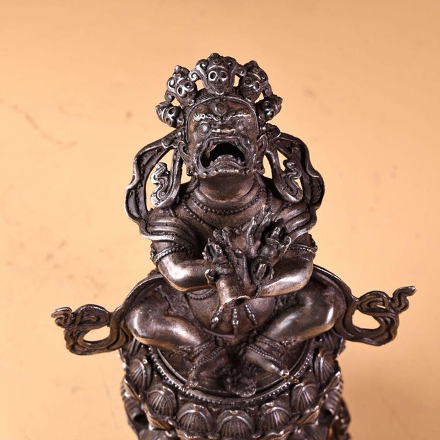 Exquisitely hand-carved Tibetan bronze incense censer featuring the Vajra deity seated atop a detailed lotus bloom. The...