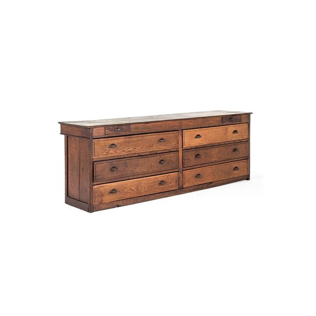 A splendid large oak haberdashery shop counter from a department store in Northern France. The generous single plank top...