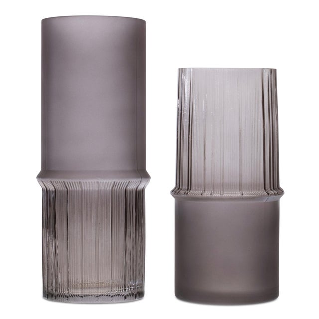 Add a touch of contemporary elegance to your living space with this set of grey glass vases. Crafted from high-quality...