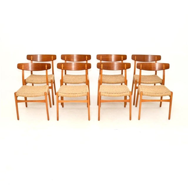 A beautiful and iconic set of eight Danish vintage CH-23 dining chairs by Hans Wegner for Carl Hansen. They were made in...