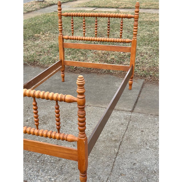 Vintage twin-sized Jenny Lind spindle or spool bed. Wood appears to be maple. This bed is a beautiful example of a coveted...