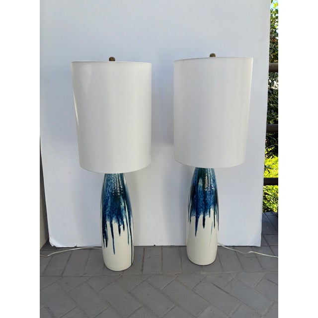 Mid Century Style White & Blue Drip Lamps - Pair. Tall cylinder shades with a gold finial. Showroom floor sample.