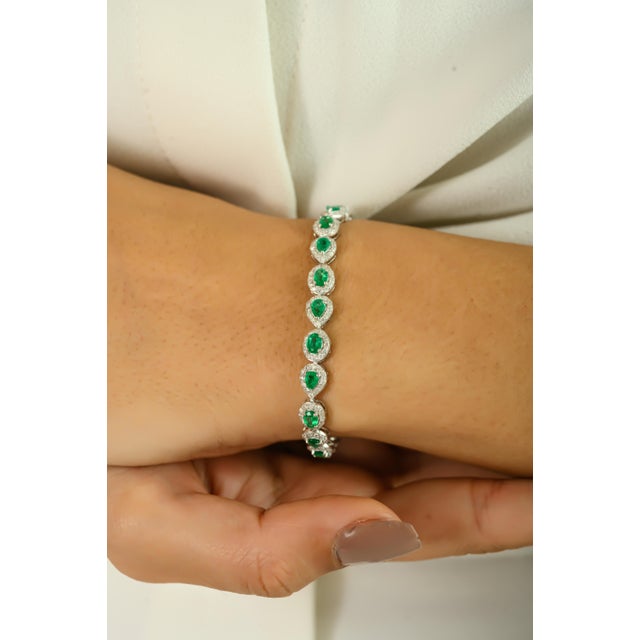 Elevate your elegance with this exquisite bracelet, crafted in luxurious 14K white gold. Featuring 3.11 carats of vibrant...