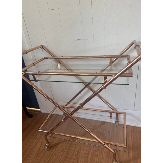 Fun and functional mid-century bar cart in a rose gold finish. The faux bamboo look and compact size make it a great fit...