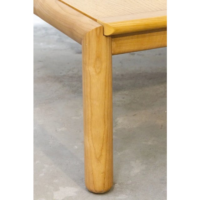 1980s square coffee table in solid ash wood Simple and elegant structure, cylindrical legs and square top with shaped and...