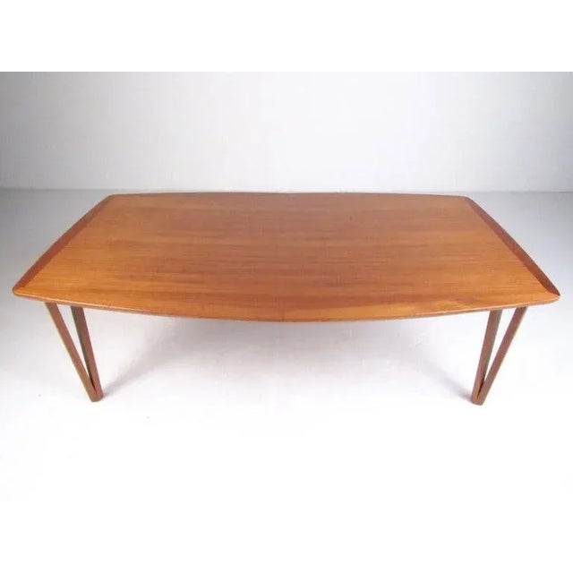This unique Mid-Century Modern coffee table features stylish and sturdy Danish teak construction and is perfect for home...