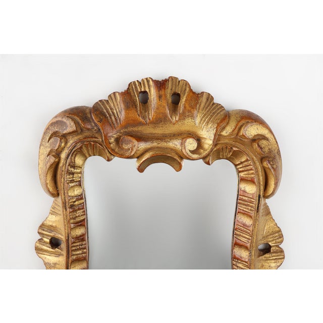 A charming French hand mirror from the mid‑20th century, carved in wood and finished with a warm gilded patina. The frame...