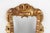 A charming French hand mirror from the mid‑20th century, carved in wood and finished with a warm gilded patina. The frame...