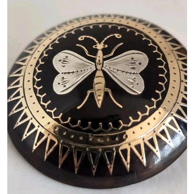 A charming late Victorian faux tortoiseshell brooch dating to circa 1880, finely decorated with gold and silver piqué work...