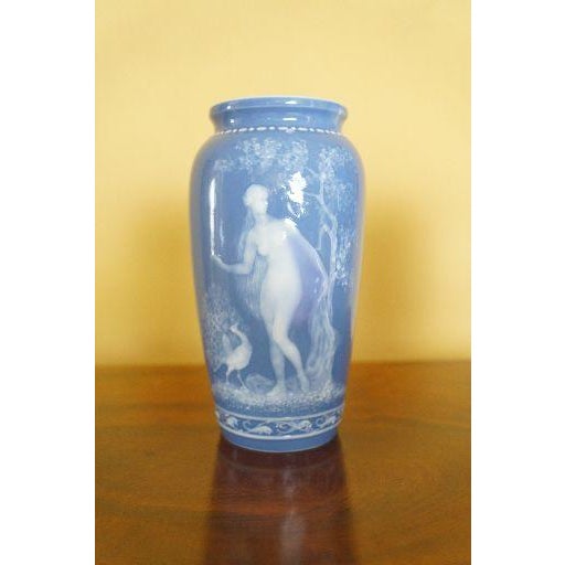 A refined pair of antique French Limoges porcelain vases decorated in the pâte-sur-pâte technique, featuring raised white...