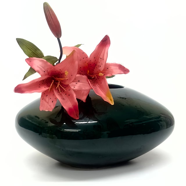 This is a rare 1980s dark forest green and black ceramic vase by Royal Imports. It is a low, rounded, oblong vase with a...