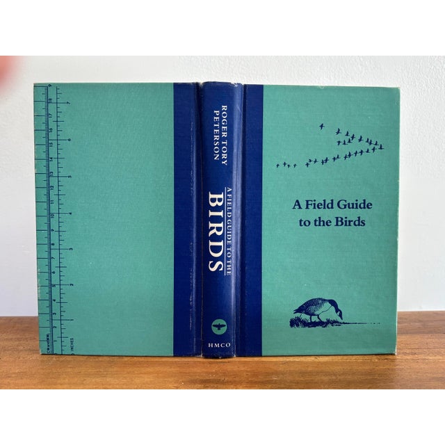 A vintage 1980s "A Field Guide to the Birds" by Roger Tory Peterson. Features pretty teal and royal blue hardcover,...
