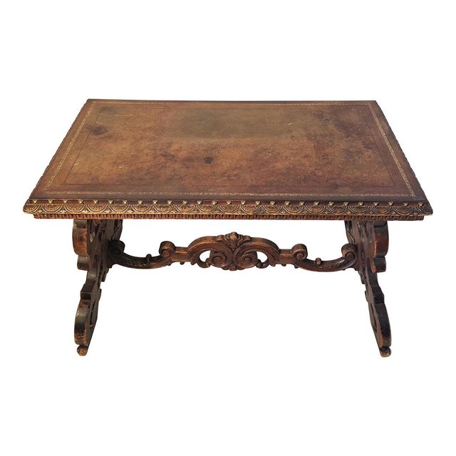 Antique 19th century writing table, solid walnut structure with carvings, leather top with studs around the perimeter....