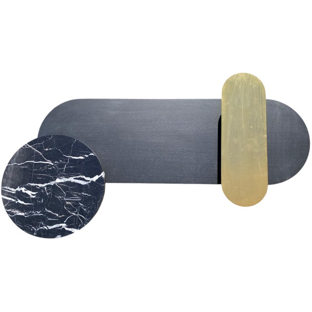 A modern sculptural table in three levels and materials. Brass, Nero Marquina marble, and Black Lacquered ash.