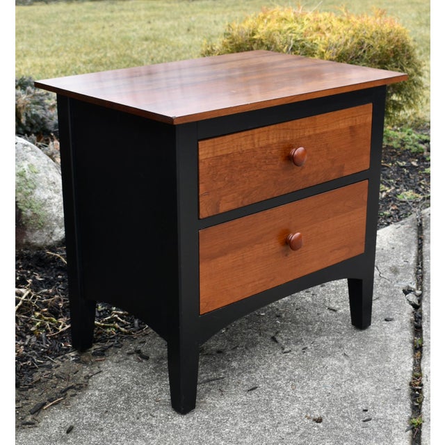 Vintage (1990's) Nightstand has a Transitional Style. Made by Ethan Allen. The Wood is CherryWood. Two Tone Finish with...
