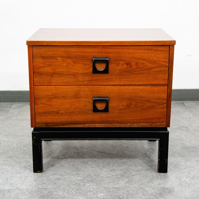 Handsome 2 drawer nightstand in walnut by dixie. Sculpted metal rounded handled within each drawer. Signed within the top...