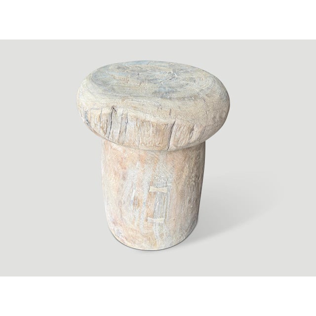 A beautiful antique rice pounder over a hundred years old has been turned upside down and repurposed as a side table....