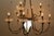 Brass 12 arm chandelier has frosted glass bobeches and a large, urn-shaped frosted center glass surrounded by laurel...