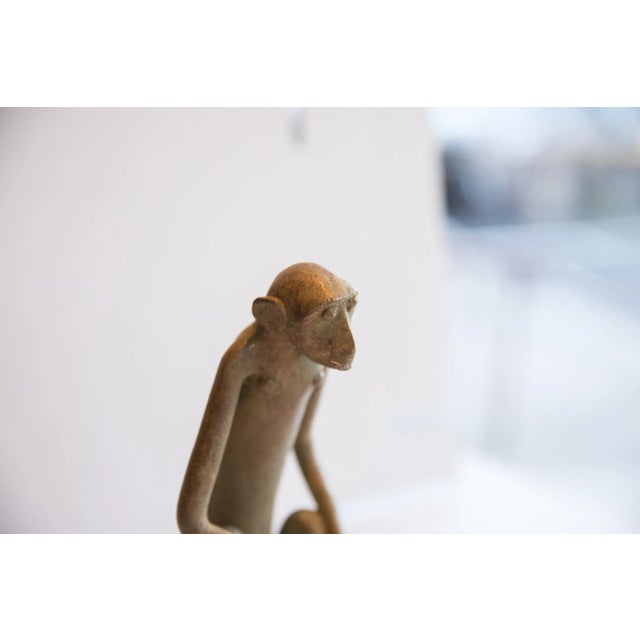 :: Vintage handmade African sitting monkey with banana sculpture. Circa late mid 20th century, each figure in this...