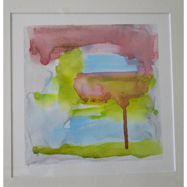 This watercolor painting is a sophisticated wash of translucent colors of deep rose pink, sky blue, apple green, and pale...