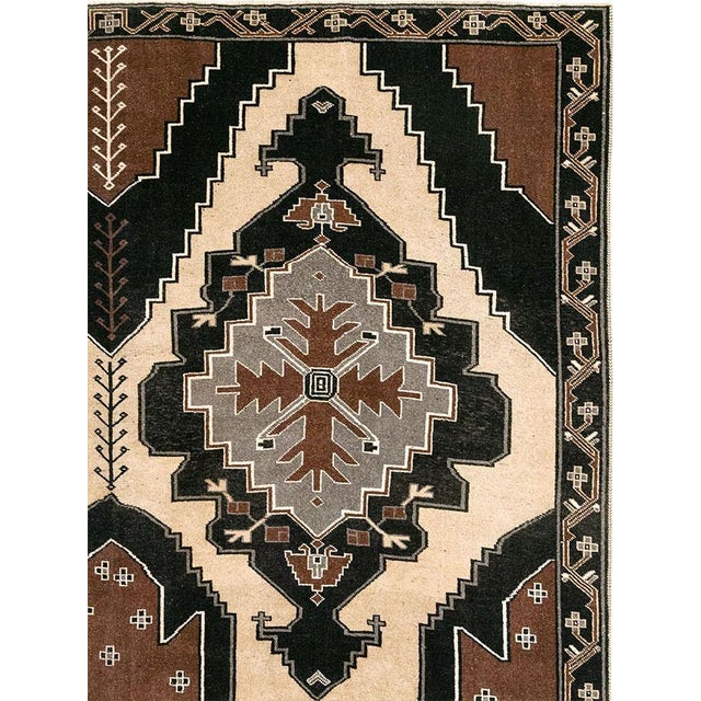 This Mid-20th century Turkish Anatolian large room-size carpet presents a bold, architectural composition in a restrained...