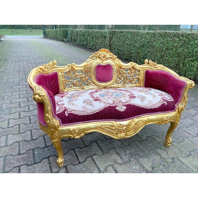 Late 20th Century French Louis XVI–Style Gilded Beech Settee in Red Velvet Elevate your interior with this striking late...