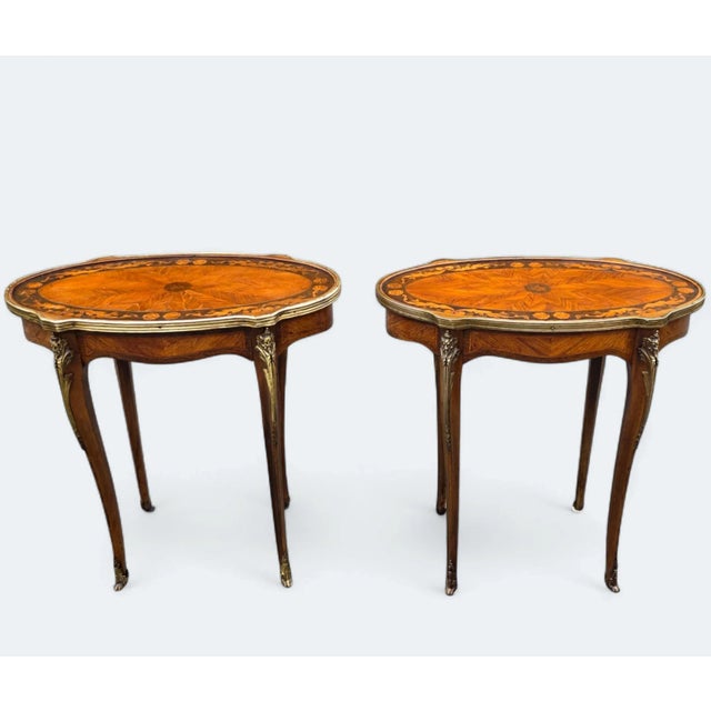 These 19th-century Louis XV-style marquetry Side Tables with Gilt Bronze Accents are a distinguished pair and heirloom...