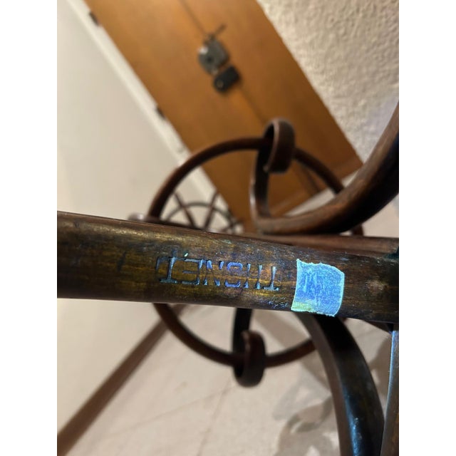 Sculptural antique bentwood coat rack attributed to Thonet, dating to the early 20th century. Features elegant steam-bent...