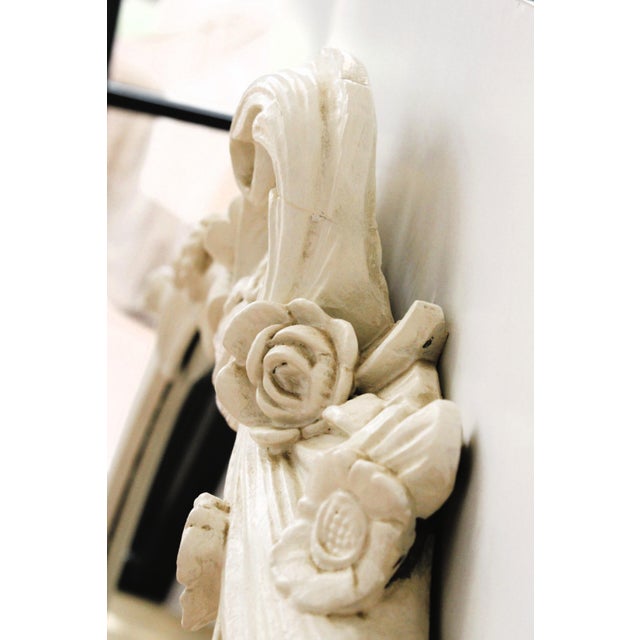 Exceptional French oval shaped wall mirror, with carved leaf's and floral relief frame. Having all the signs of a natural...