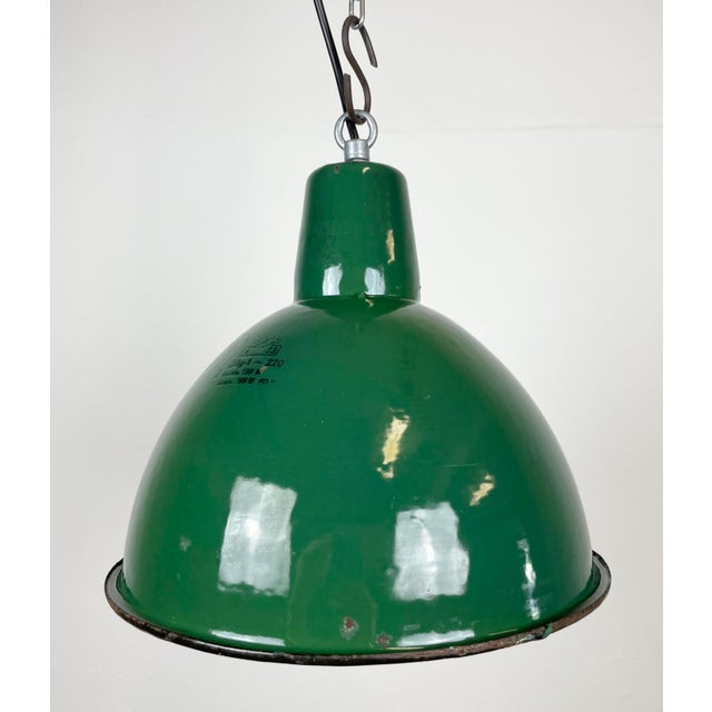 Industrial green enamel pendant light made by Polam Wilkasy in Poland during the 1960s. White enamel inside the shade....