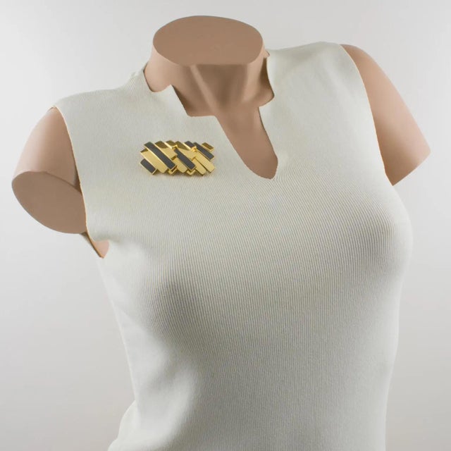 This stunning Lanvin Paris modernist pin brooch is a statement piece from the early 1970s. It features a massive gilded...