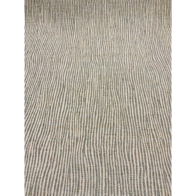 This stylish organic modern light celadon and white woven striped fabric has a medium hand and is suitable for upholstery,...