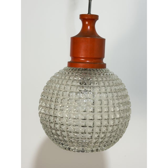 Spherical chandelier in thick glass, made in Italy, 1970 Orange metal frame. Glass intact, good condition (the frame shows...