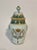 A rare Desvres French faience lidded jar in the style of Quimper Porquier Beau. It features a Breton playing a biniou...