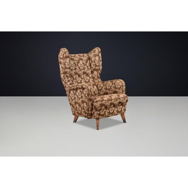 Architectural Art Deco wingback chair from Prague, circa 1940s, preserved in fully original condition with sculptural...