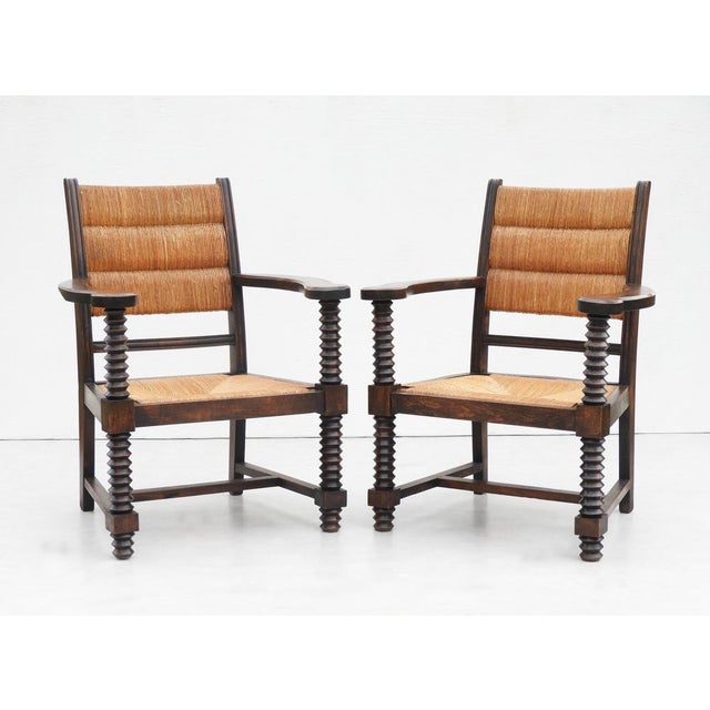 Fabulous and increasingly rare pair of French Oak & Rush Armchairs by Charles Dudouyt C1940s France A striking pair of...
