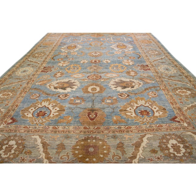 Beautiful modern Sultanabad hand-knotted wool rug with a blue field. This Sultanabad rug has brown, terracotta, and peach...
